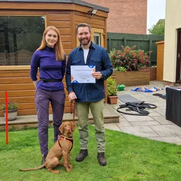 Happy client with their dog after completing training