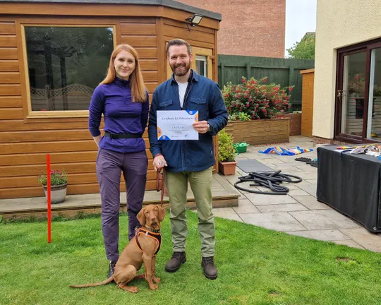A family enjoying a training session with their dog in Edinburgh